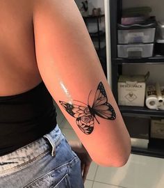 a woman's arm with a butterfly tattoo on the left side of her body