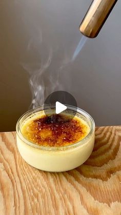 a bowl filled with food sitting on top of a wooden table