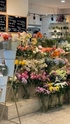 a flower shop filled with lots of different types of flowers