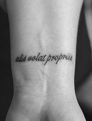 a black and white photo of a person's wrist with the words, all we eat propress written on it