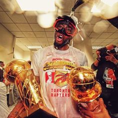 a man holding three golden basketballs in his hands and wearing goggles on his head