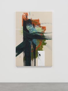 an abstract painting hangs on the wall