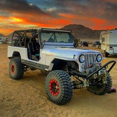 the jeep is parked in the desert with its doors open and it's wheels down