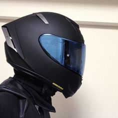 a person wearing a black jacket and helmet