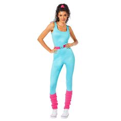 a woman in a blue jumpsuit and pink boots posing for the camera with her hands on her hips