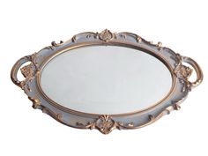 an ornately decorated oval mirror with gold trimmings on the edges and sides