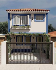 a white and blue house with a gate