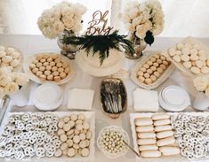 a table topped with lots of food and desserts