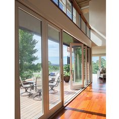 the inside of a house with wood floors and sliding glass doors