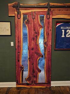 Bring a touch of natural elegance and artistry to your home with my Live Edge Cedar Door. This isn't just any door--it's a striking feature that will set your space apart. Each door is crafted with care, blending the rugged beauty of cedar with a smooth hand-forged epoxy resin finish and intricate wrought iron accents. This wooden door offers a perfect mix of rustic charm and modern style. Picture a door that highlights the unique contours of live edge wood, finished with sleek epoxy resin and adorned with timeless wrought iron details. Whether you're updating your home or adding a standout feature, my Live Edge Cedar Door is designed to catch the eye and add a touch of sophistication. This interior door is ideal for anyone looking for a distinctive and stylish addition to their home decor Wood And Epoxy Door, Live Edge And Resin Barn Door, Reclaimed Wood Barn Door, Cedar Projects, Teak Wood Barn Door, Rustic Single Barn Door, Farmhouse Fireplace Decor, Cedar Door, Cedar Furniture