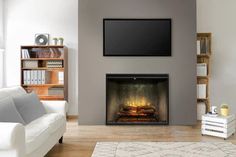 a living room with a couch, fireplace and television mounted on the wall above it