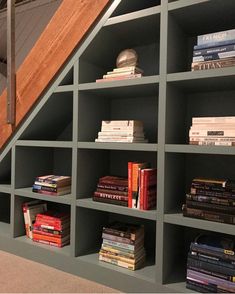 the bookshelves are filled with many different types of books and have stairs leading up to them