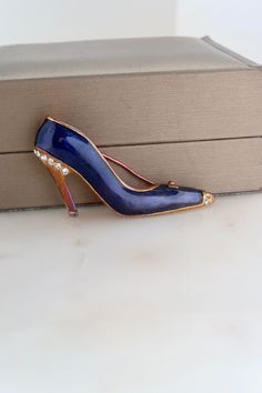 Vintage Navy Blue Gold High Heel Shoe Brooch. Length: 1" Width: 2 1/8" Vintage condition! missing crystals please zoom in. Back to the shop: https://www.etsy.com/shop/SusVintage?ref=hdr_shop_menu Don't hesitate to contact me if you have any further questions. Thank you for looking!! Gold High Heels, Blue Gold, High Heel Shoes, Navy Blue, Navy, Bathing Beauties, Accessory Gift, Heels, Electronic Accessories