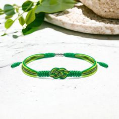 ♡ GREAT KEEPSAKE: Green Multiple Color Infinity String Bracelet, Forever Lucky and Safe Multiple Color Tibetan Bracelet, Protection Surfer String Wrap Bracelet ♡ UNIQUE ART AND DESIGNS: MeeKnots, where every piece is carefully crafted by skilled artisans using the finest quality materials. We believe that jewelry should be a reflection of the wearer's unique story, and we are passionate about creating pieces that capture that essence. With a focus on quality, creativity, and sustainability, our brand offers a truly unique and meaningful jewelry experience. Handmade bracelet with infinity symbol, protective. Timeless elegance, comfort fit. A meaningful gift, embodying positivity and resilience. ♡ MEANINGFULL MESSAGES TO RECEIVER: Our bracelets carry a meaningful message of pride, unity, and Cheap Green Jewelry With Sliding Knot, Tibetan Bracelet, Meaningful Jewelry, Protection Bracelet, String Bracelet, Multiple Color, Meaningful Gifts, Handmade Bracelets, Arm Band