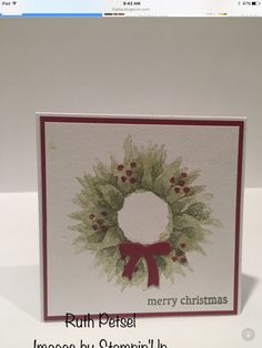 a christmas card with a wreath on it