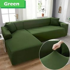 a living room with a large green sectional couch