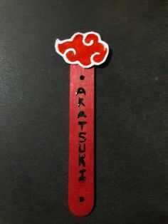 a red stick with writing on it sitting on top of a table