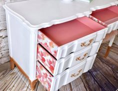 a white desk with pink drawers and gold trim