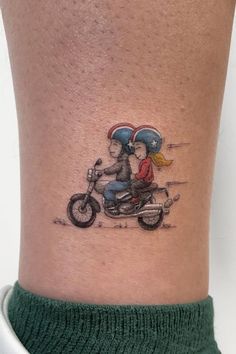 a couple riding on a motorcycle with an umbrella tattoo