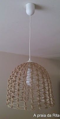 a light fixture hanging from the ceiling in a room with white walls and flooring