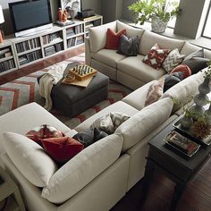 a living room filled with lots of white furniture