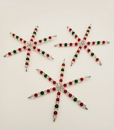 a christmas ornament with red, green and white beaded stars on it