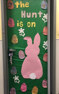 the bunny is on bulletin board in front of a door