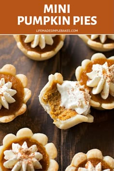 mini pumpkin pies with whipped cream and cinnamon on top, sitting on a wooden table