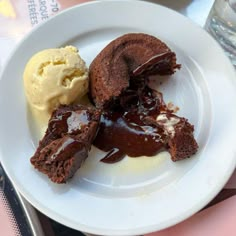 a white plate topped with chocolate cake and ice cream