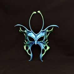 a blue and green mask on a black background