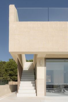 a white building with stairs leading up to it