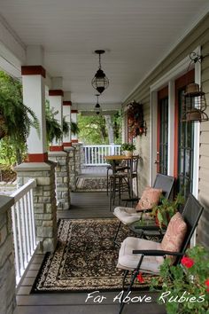 a porch with chairs and rugs on it