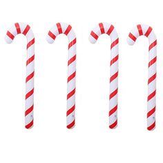 three candy canes are lined up in the same row, one red and white