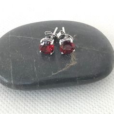 These womens red stone stud earrings are vintage, sterling silver jewellery. A lovely bright colour, the red earrings are prong set in a high base. Pretty red studs.         The womens earrings are in excellent condition, with brand new butterfly backs. They have been thoroughly cleaned as well. The stud earrings are just under 1/4 inch (5mm) in diameter.  FREE shipping in the UK. Choose a bracelet too: https://www.etsy.com/uk/shop/ReTainReUse?section_id=14455987 You can see other gift ideas her Red Round Earrings For Anniversary, Red Pierced Earrings For Anniversary, Garnet Gemstone Earrings, Red Classic Jewelry With Matching Earrings, Classic Red Jewelry With Matching Earrings, Formal Red Earrings With Prong Setting, Red Round Anniversary Earrings, Luxury Red Round Anniversary Earrings, Red Fine Jewelry Earrings For Anniversary