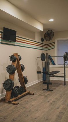 a home gym with several different types of exercise equipment in the room and on the wall