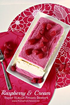 raspberry and cream dessert on a red doily with a fork next to it