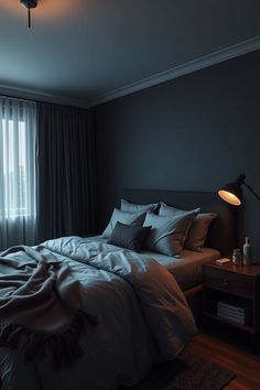 a bed sitting in a bedroom next to a window covered in blankets and throw pillows