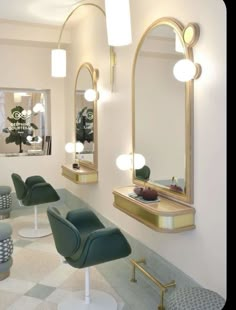 a hair salon with chairs, mirrors and lights on the wall in front of them