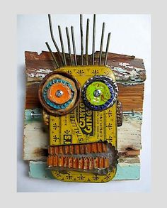 an art piece made out of scrap wood and other items is displayed on the wall