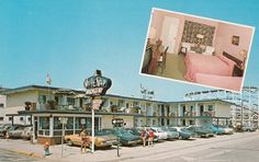 an old motel with cars parked on the side of the road and people standing outside