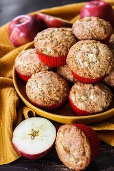 apples and muffins on a yellow plate next to an orange towel