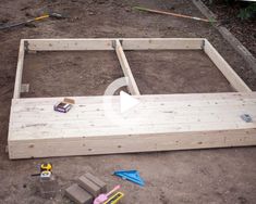 an unfinished bed frame is being built on the ground