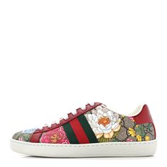 This is an authentic pair of GUCCI GG Supreme Monogram Flora Web Womens Ace Sneakers Size 35 in Beige, Multicolor and Rosso. These stylish sneakers are crafted of beige Gucci GG monogram coated canvas, with a vibrantly colored floral print overlay, and red leather trim. The shoes feature white rubber soles, matching laces, a red and green nylon web stripe at the sides, and metallic red and green leather accents at the heel. Gg Monogram, Leather Accents, Stylish Sneakers, Green Leather, Leather Trim, Leather Trims, Red Leather, Floral Print, Floral Prints