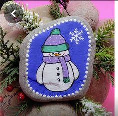 a painted rock with a snowman on it