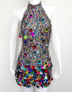 a mannequin wearing a multicolored dress with lots of buttons on it