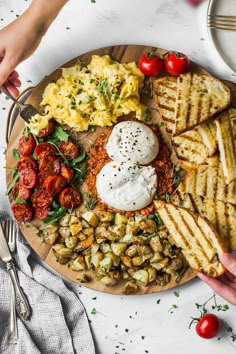 a plate filled with different types of food on top of a white table next to utensils