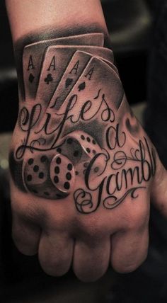 a man's hand with a tattoo on it that says life is a game