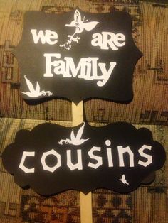 two wooden signs that say we are family and couisins on top of each other