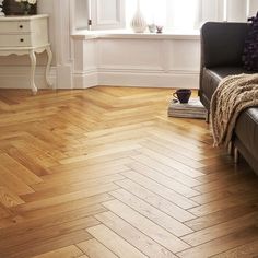 a living room with wood floors and white walls