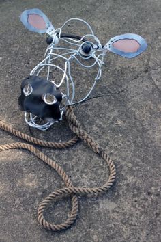 a metal cow head on top of a rope